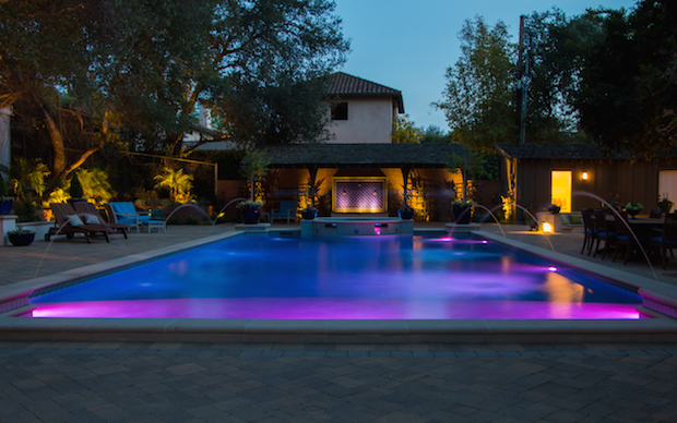 Swimming Pool at Dusk with Pool Lights and Water Jets